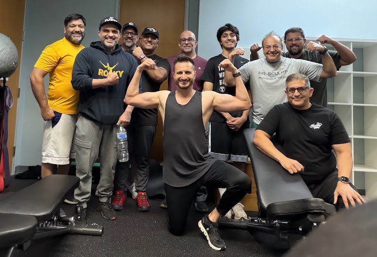 Asim Khan with the group he leads in strength training at Empire Training Grounds