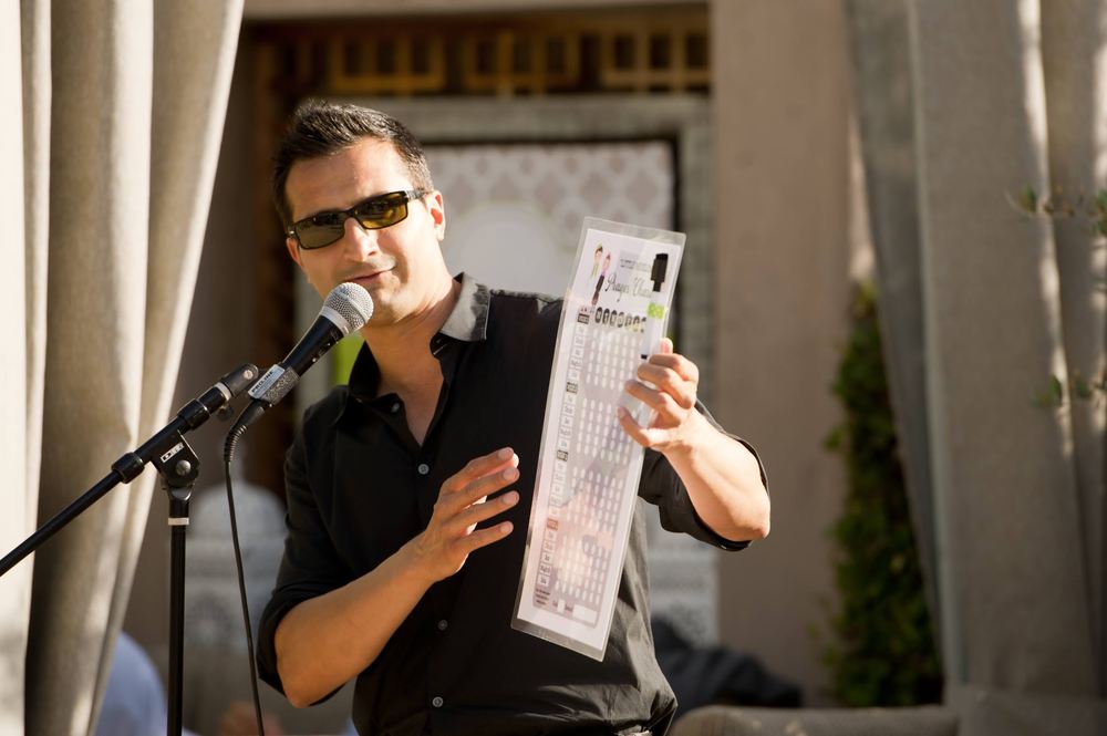 Asim Khan working a crowd with a handheld microphone