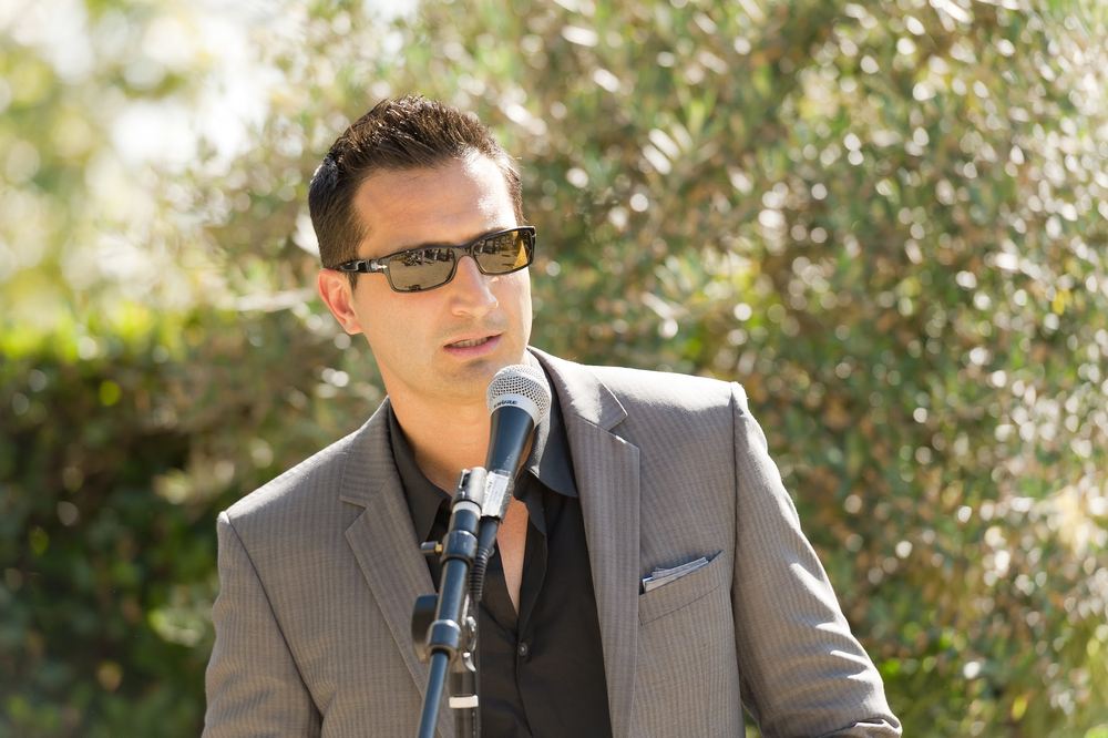 Asim Khan speaking at an outdoor program