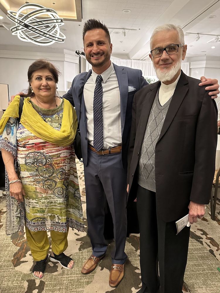 Asim Khan with guests at an Olive Community Services event