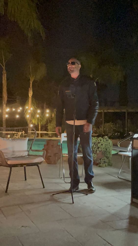 Asim Khan performing at an evening event
