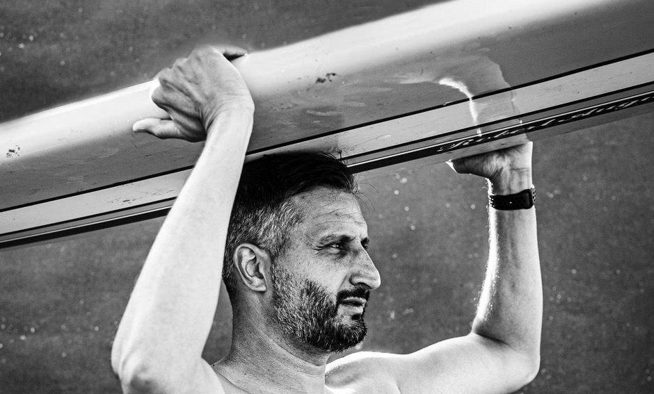 Asim Khan carrying a surfboard