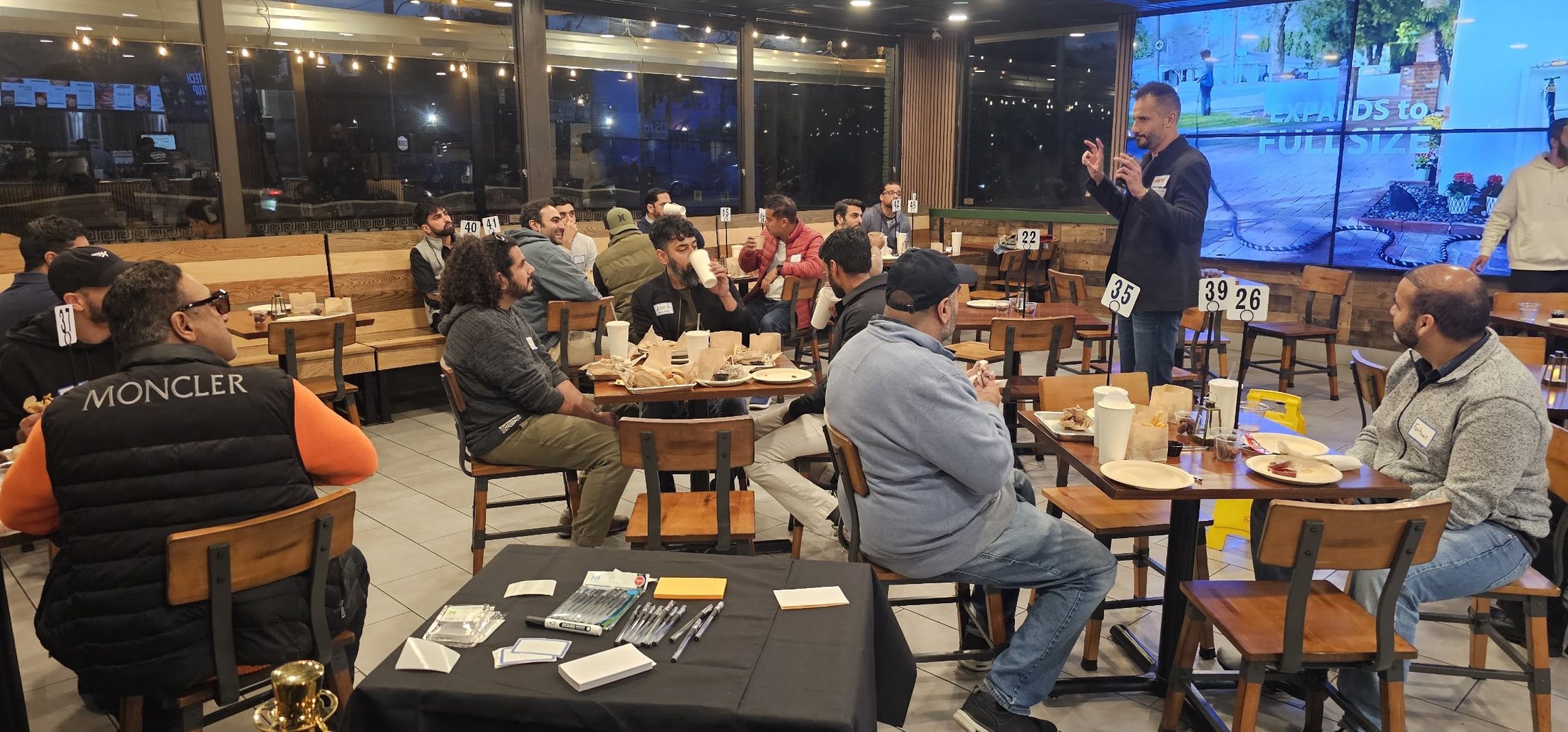 Asim Khan speaking to a young professionals group