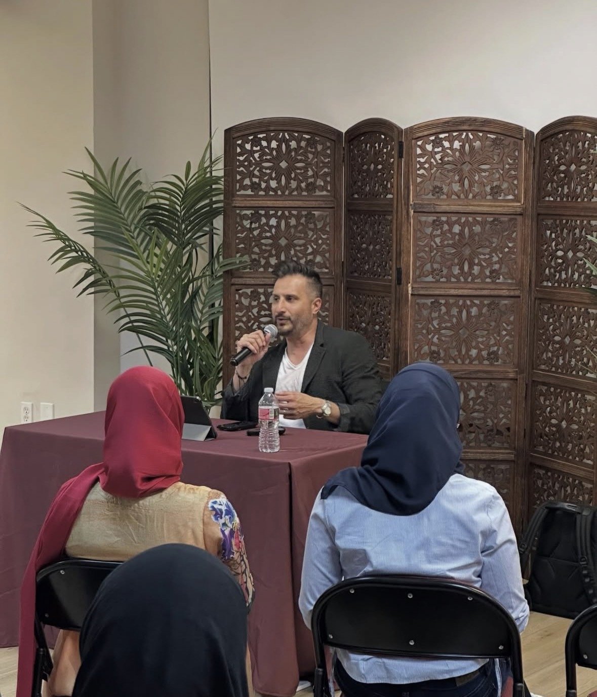 Asim Khan speaking to an organization audience
